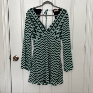 Mini dress with long flowing sleeves and open back